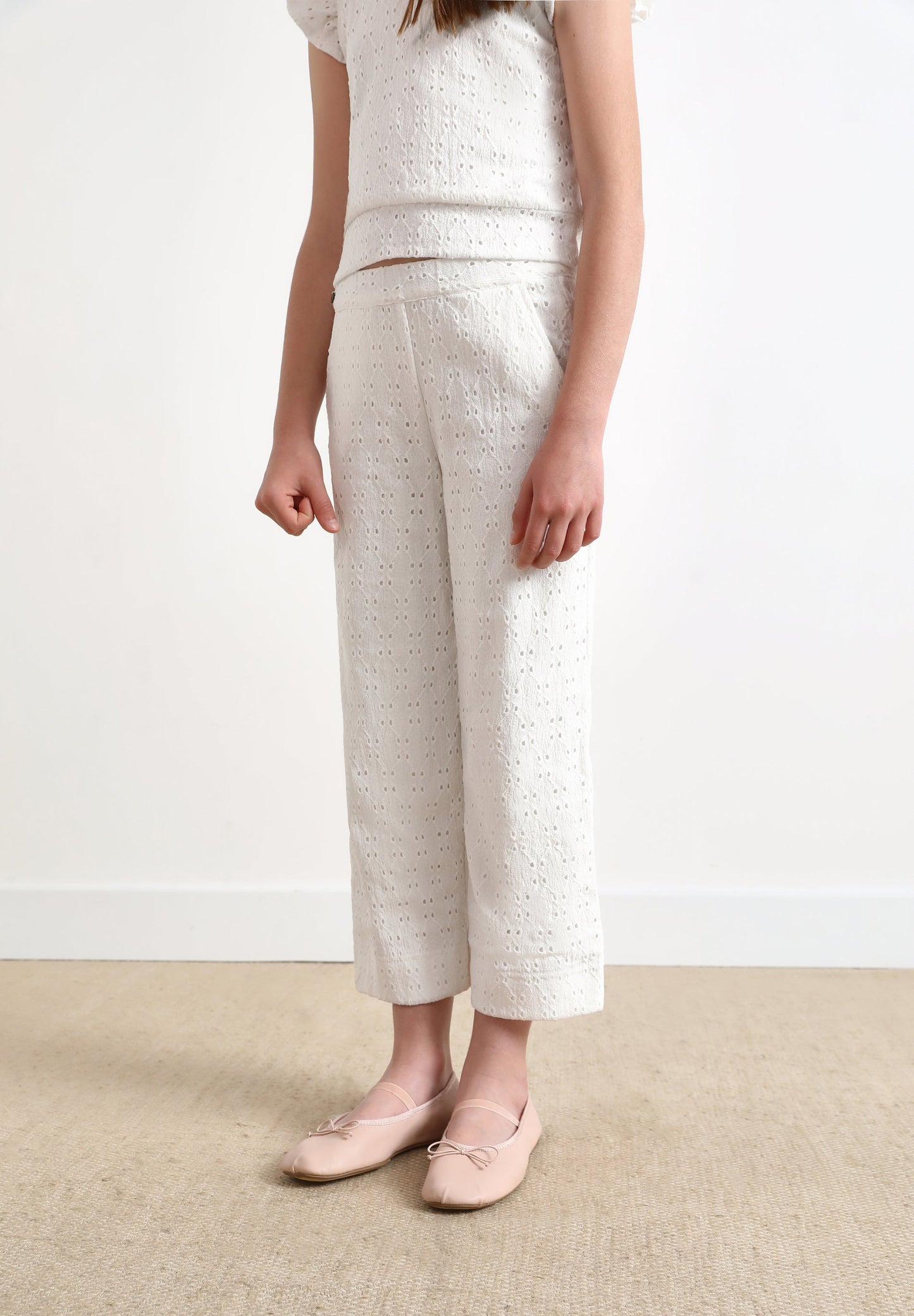 TROUSERS WITH OPENWORK DETAILS