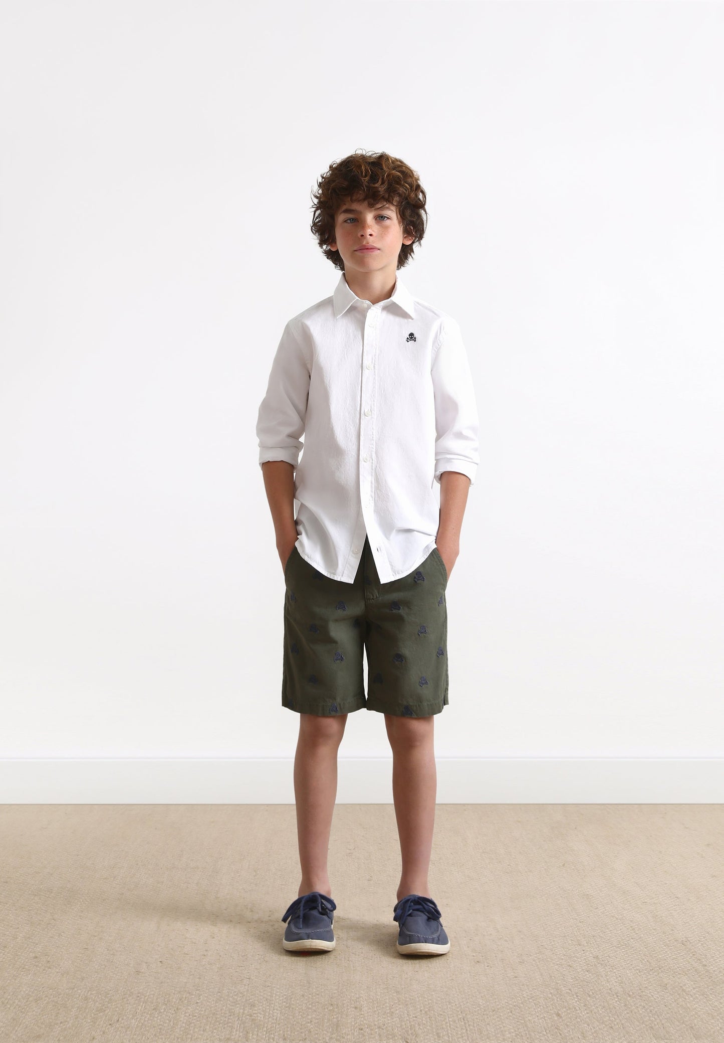 BERMUDA SHORTS WITH ALL-OVER SKULL PRINT