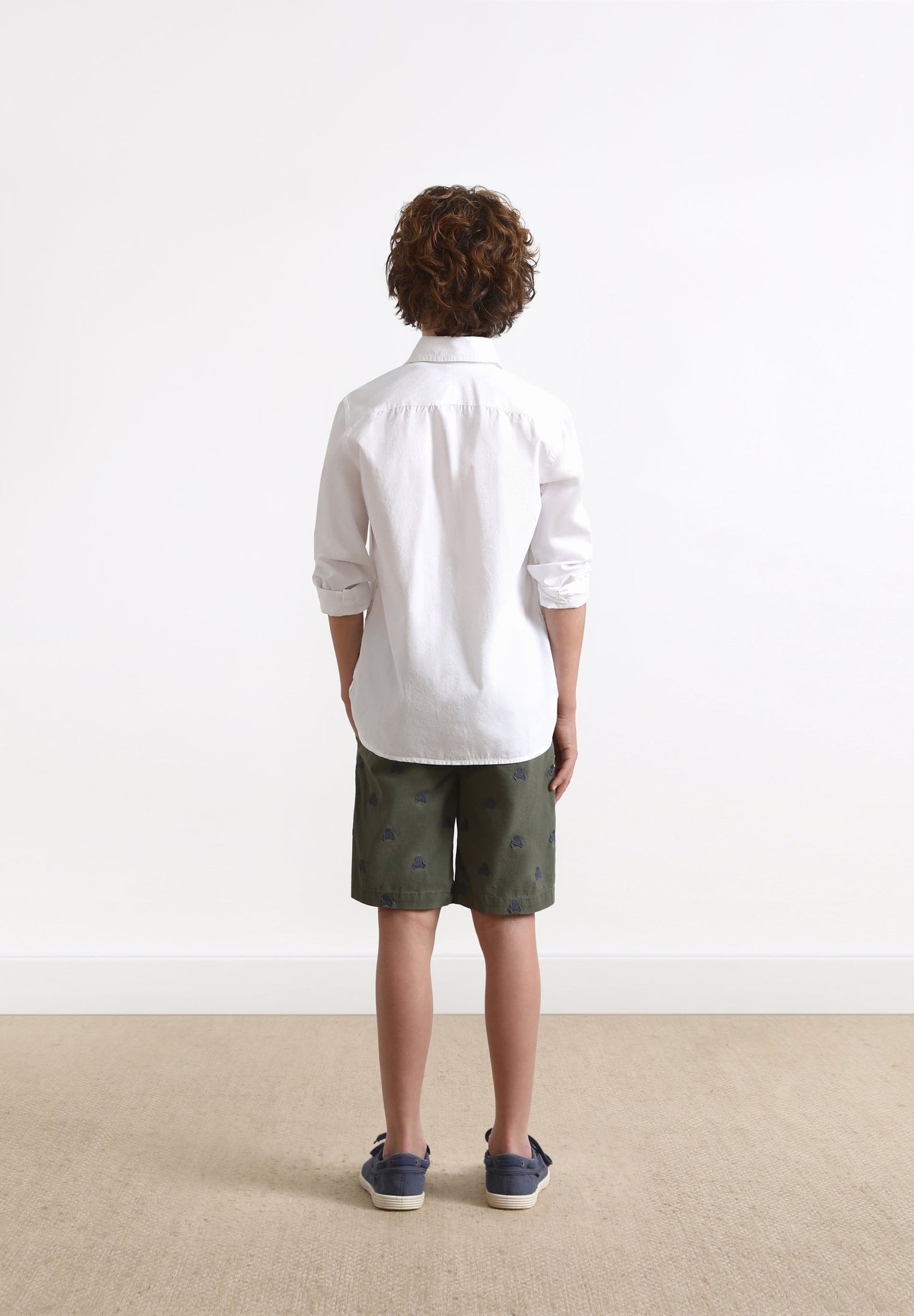 BERMUDA SHORTS WITH ALL-OVER SKULL PRINT