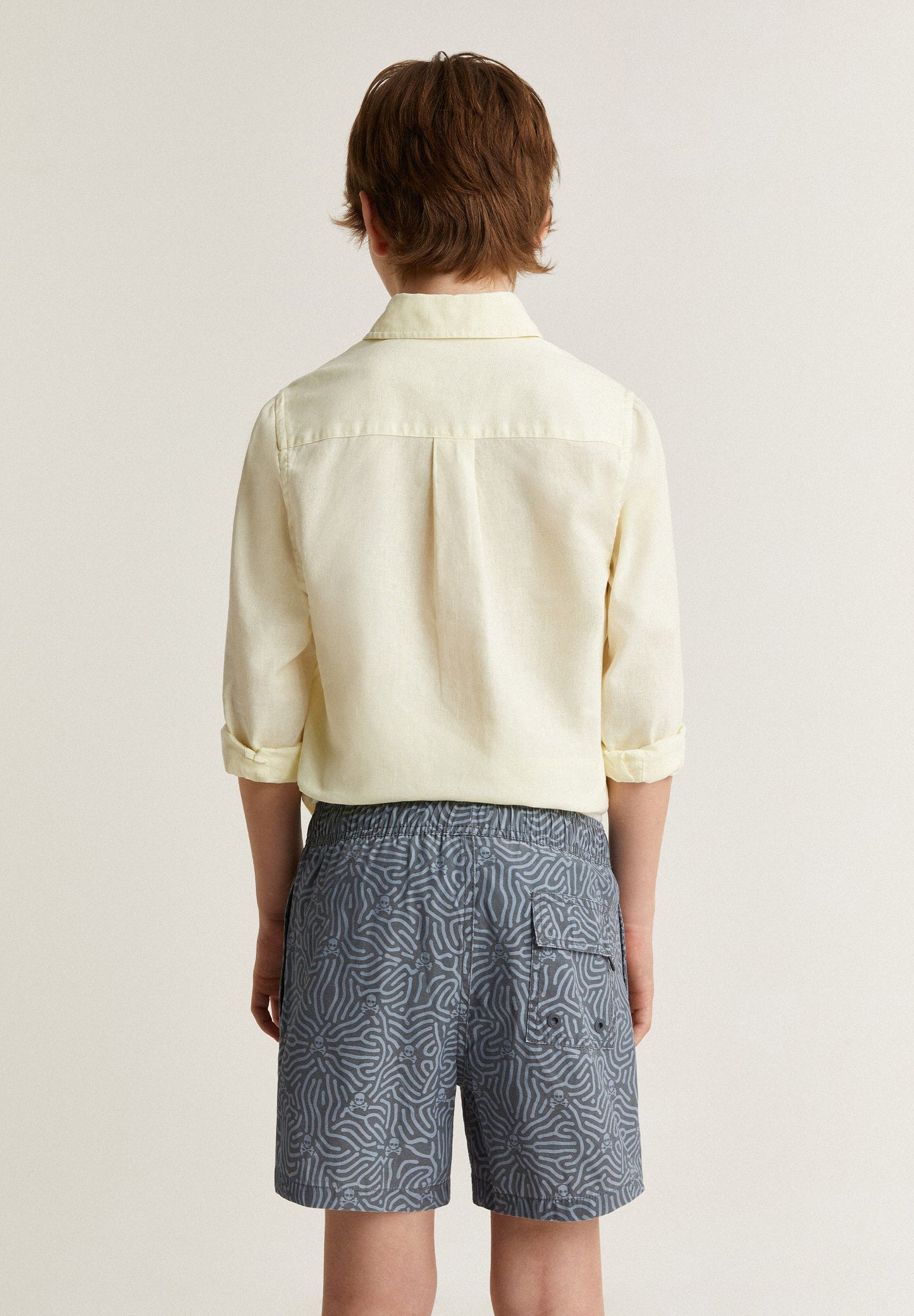 SWIMMING TRUNKS WITH ALL-OVER SKULLS DETAIL