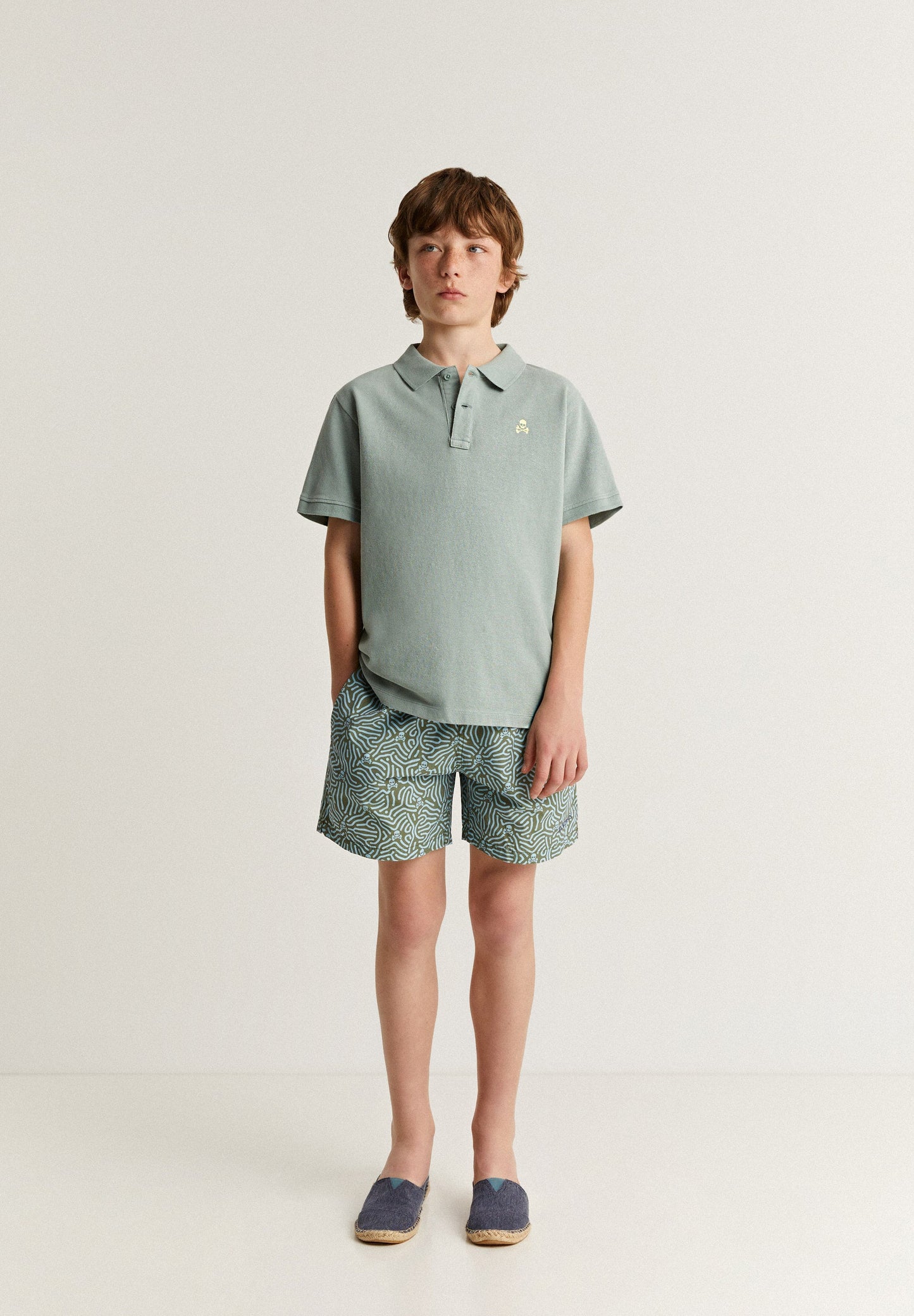 SWIMMING TRUNKS WITH ALL-OVER SKULLS DETAIL