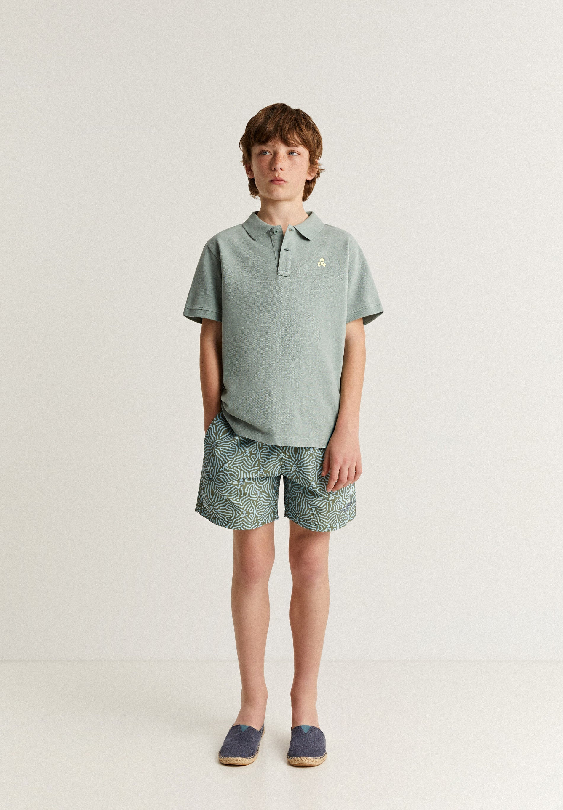 SWIMMING TRUNKS WITH ALL-OVER SKULLS DETAIL