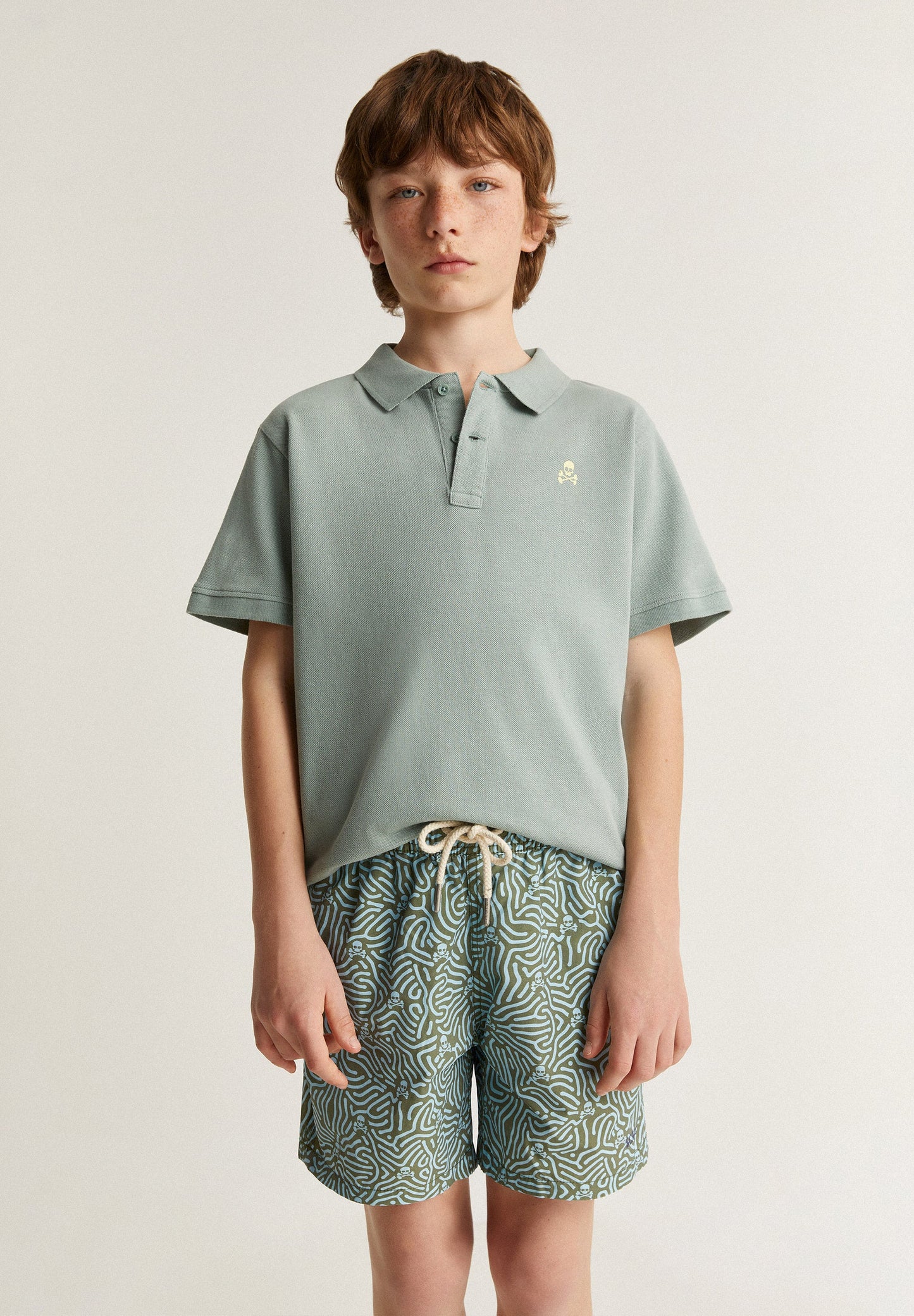 SWIMMING TRUNKS WITH ALL-OVER SKULLS DETAIL