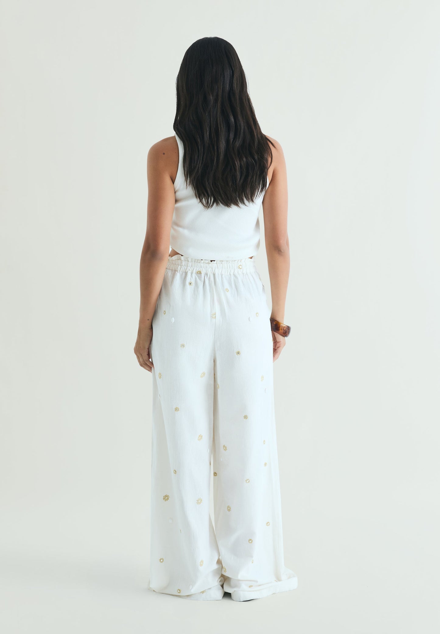 TROUSERS WITH METALLIC DETAILS