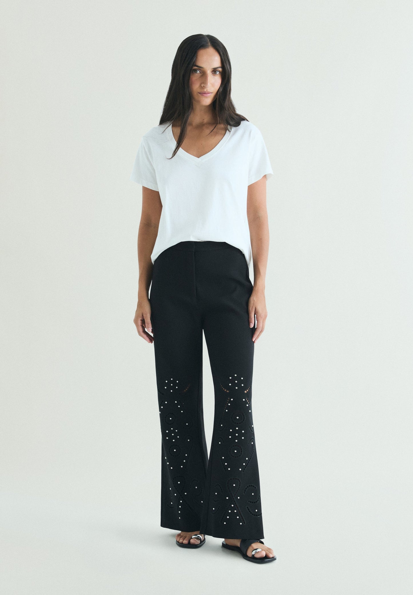 TROUSERS WITH PERFORATED DETAILS