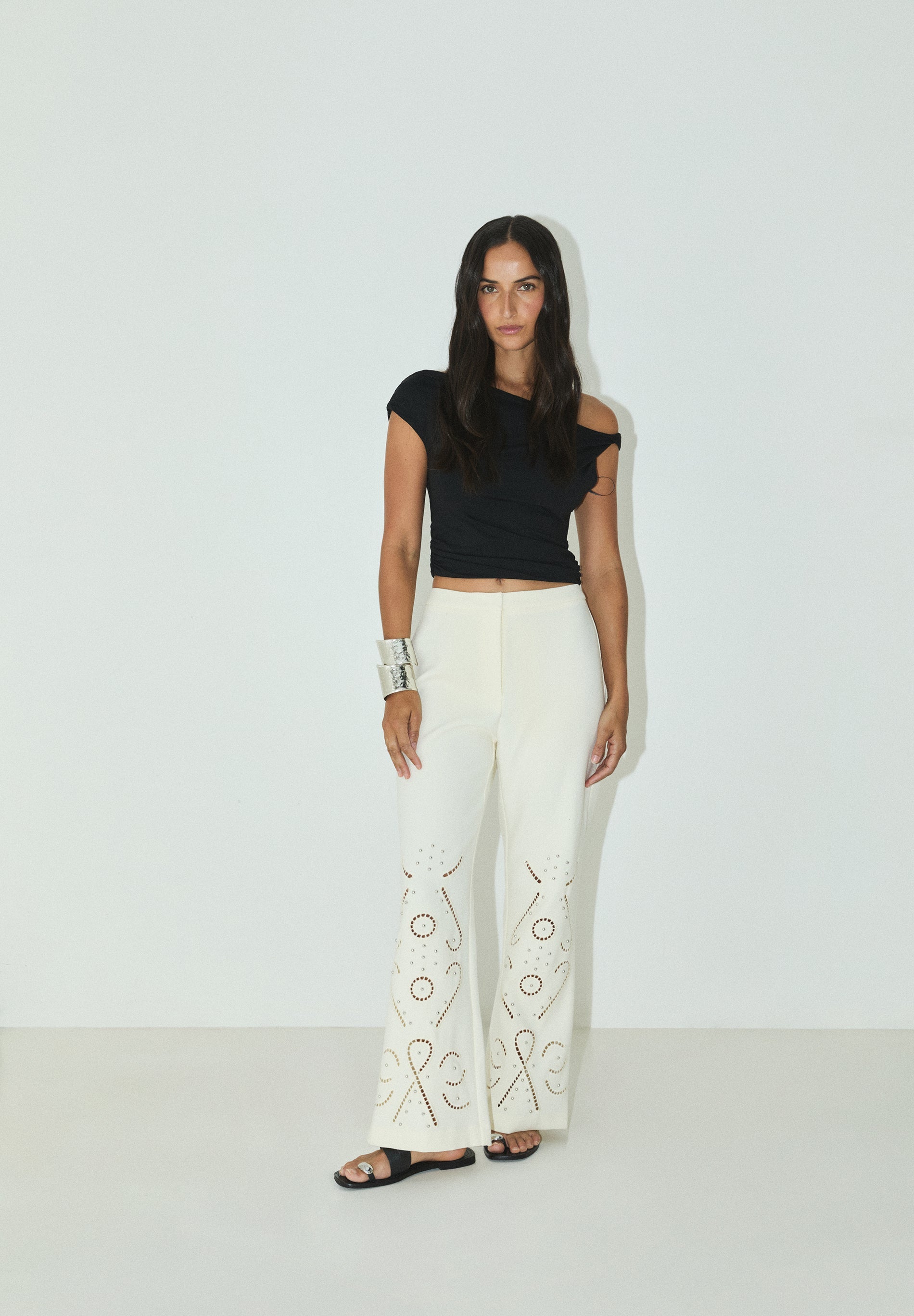 TROUSERS WITH PERFORATED DETAILS