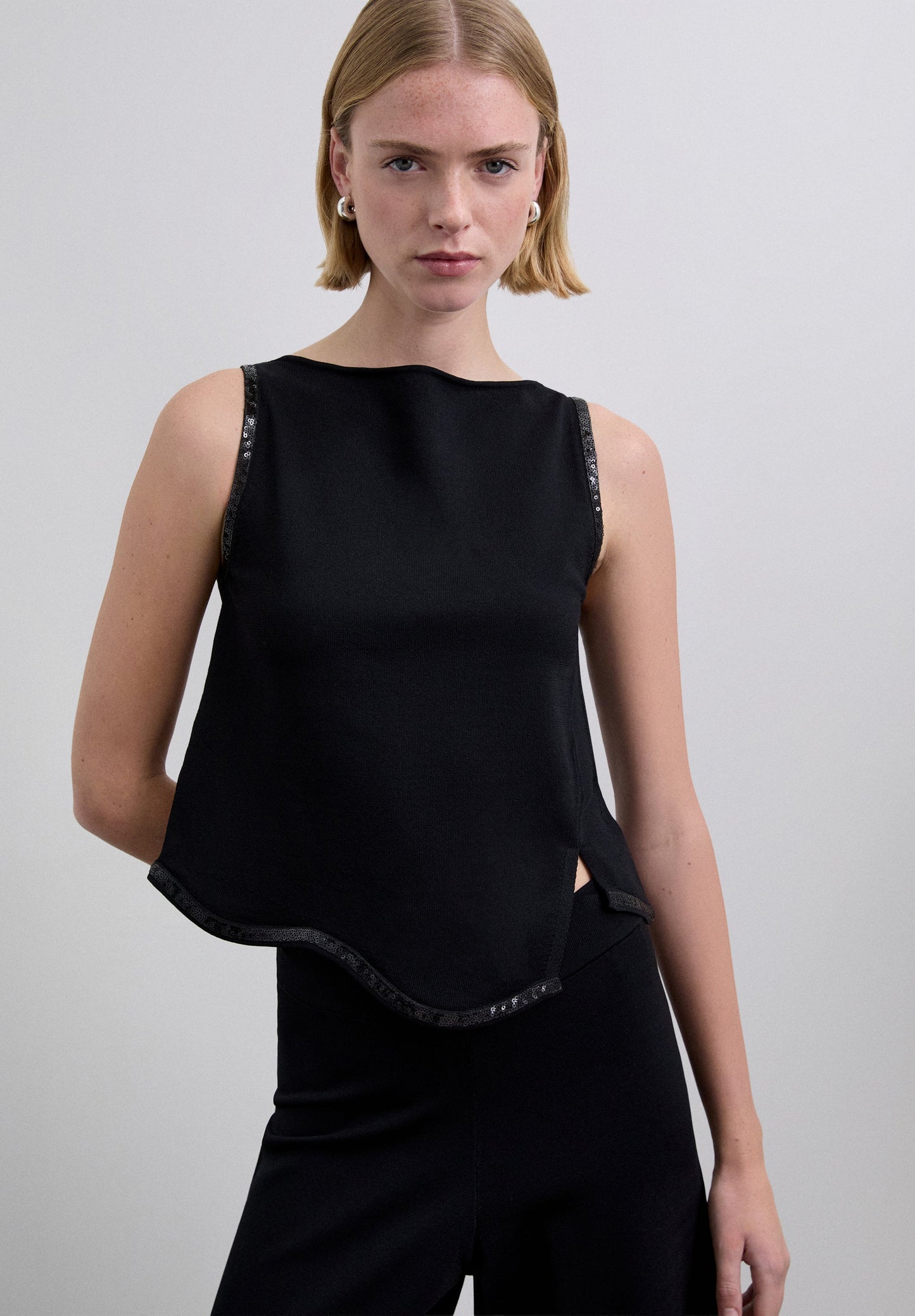 SEQUINNED TOP WITH WAVED HEM