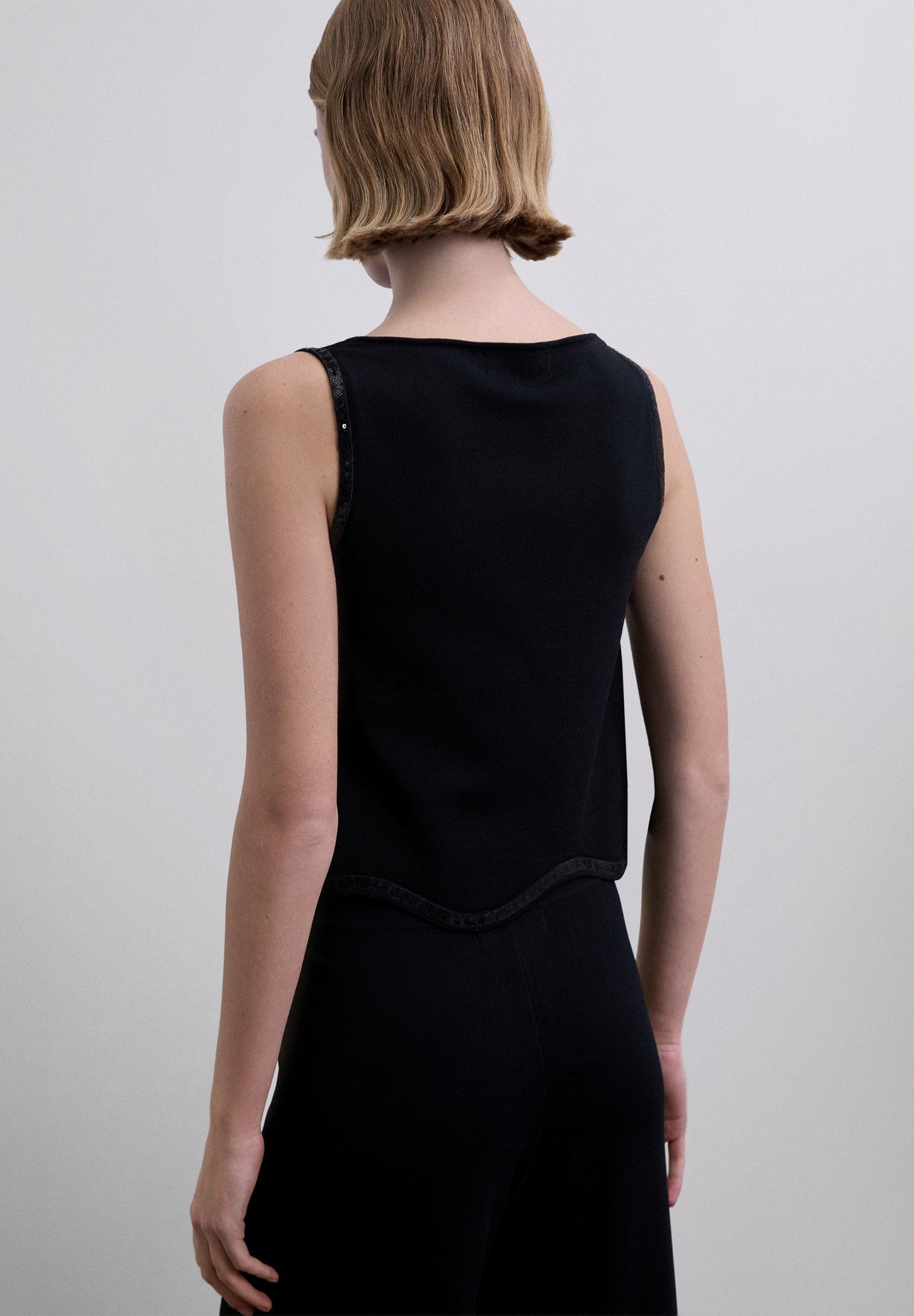 SEQUINNED TOP WITH WAVED HEM